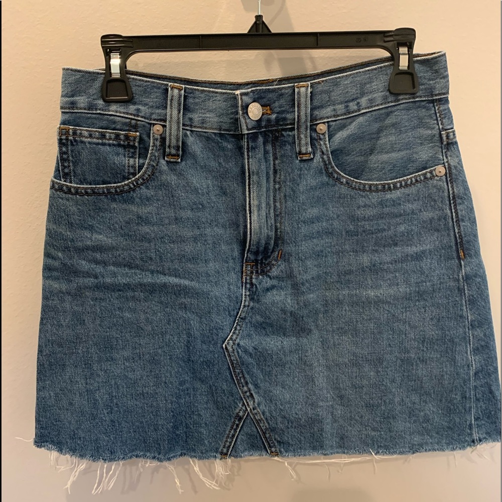 Rigid denim a-line mini skirt with raw hem